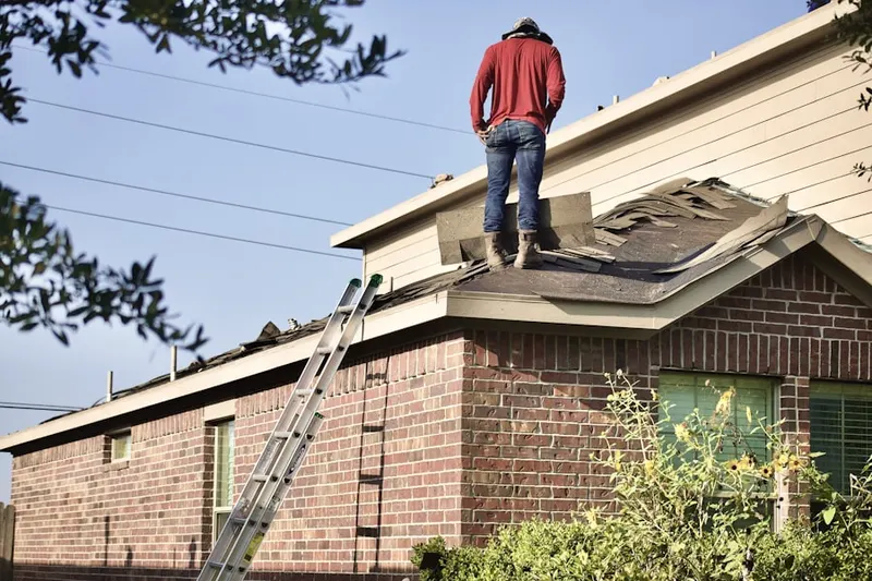 Professional roofer working on a residential roof in Columbiad Plaza